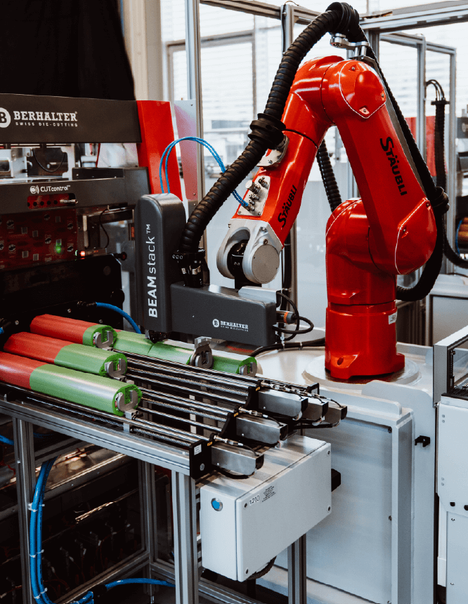BEAMstack™ robotic arm automatically stacking die-cut pieces on a packaging line