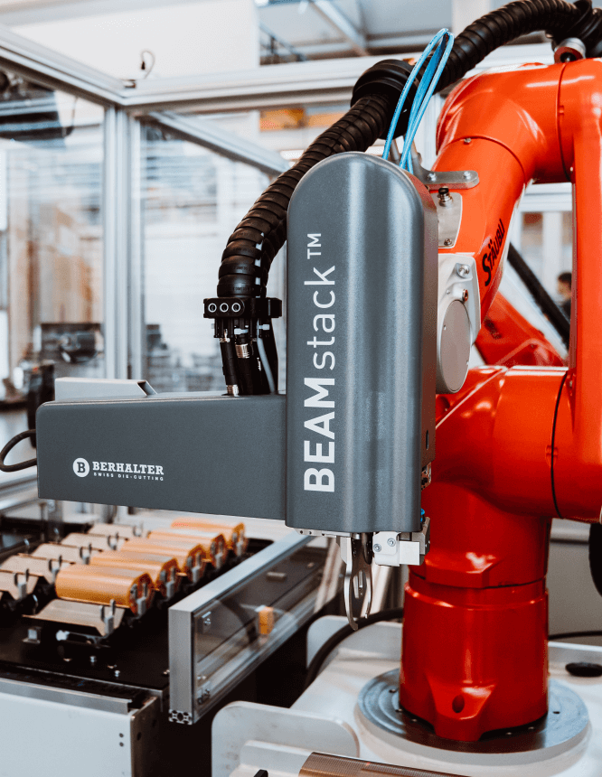 BEAMstack™ robotic gripper precisely handling die-cut stacks for automated packaging.