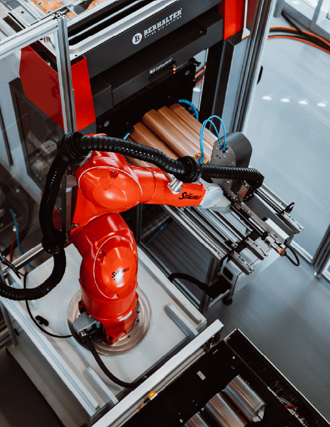 BEAMstack™ robotic arm in top view, handling die-cut stacks for automated packaging.