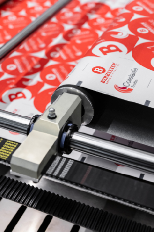 Close-up of foil feeding during material testing at BERHALTER Swiss Die-Cutting.